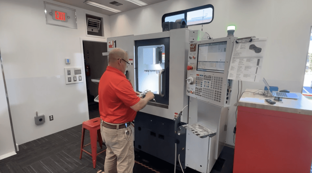 ACE trainer Mike Sundblad at the CNC mill inside the Minnesota ACE trailer.