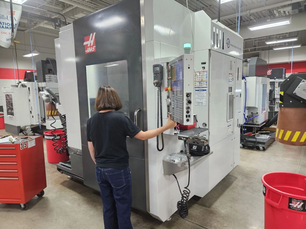 A WSU Tech ACE participant works on a CNC machine